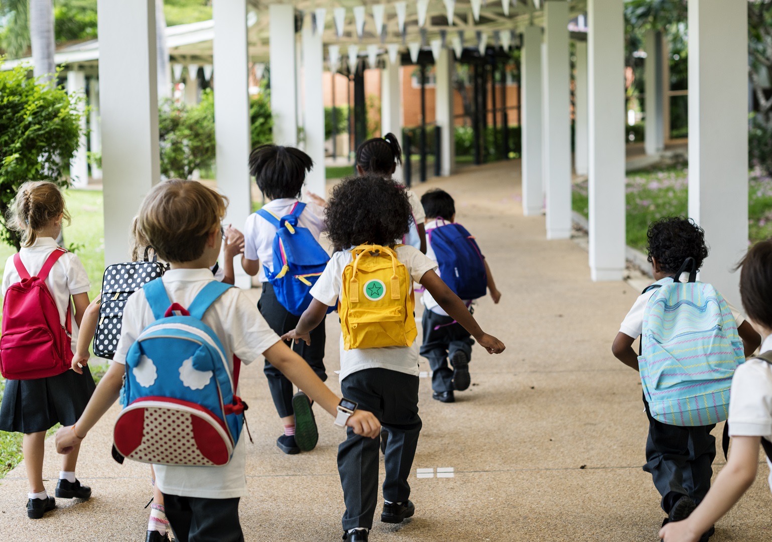 Elementary children heading into a school building